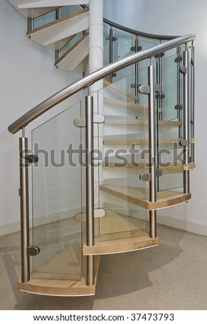 solid newel stairs with wooden steps, and glass and steel rail