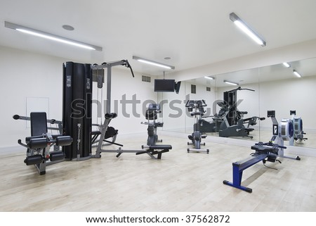 modern gym in leisure center with mirror wall and fitness machines