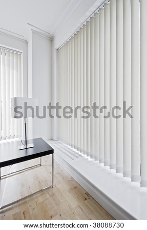 vertical fabric blinds on floor to ceiling windows
