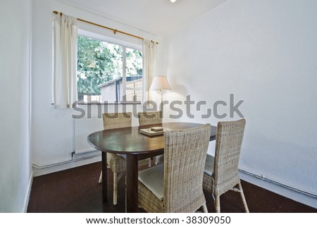 dining area with oval wood table and knitted bamboo chairs
