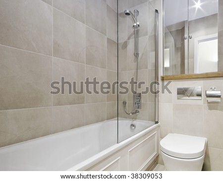 modern bathroom with white ceramic appliances and beige floor to ceiling tiles
