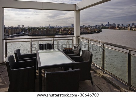 penthouse terrace with river and city views and with glass top dining table