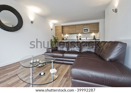Open plan living room with large leather corner sofa