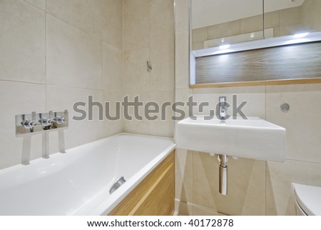 modern bathroom with designer appliances and floor to ceiling tiles