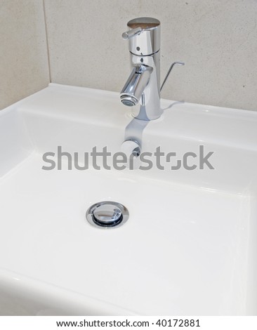 Luxury modern bathroom detail with designer water mixer tap