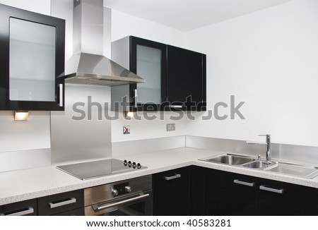 Contemporary Kitchen With A Black Piano Finish And Granite Worktop ...