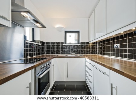 modern kitchen with black ceramic tiles and wooden worktop