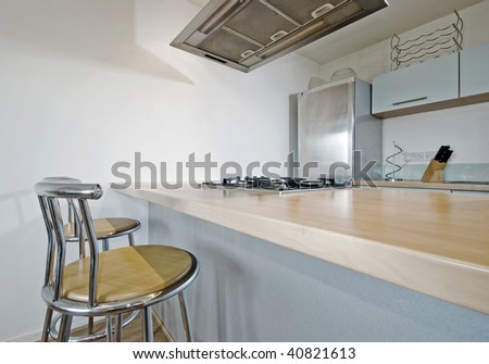 modern kitchen with breakfast bar and tall bar chairs