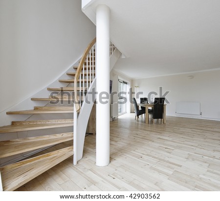 open plan living room of a duplex apartment with staircase