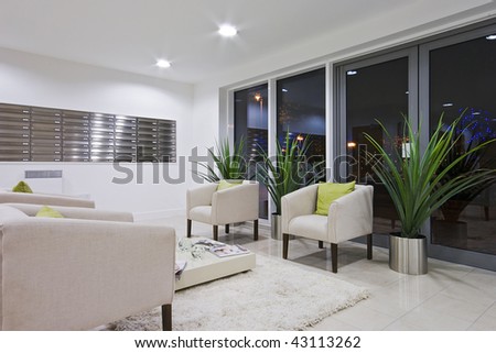 hallway of a modern development with post room and sofas