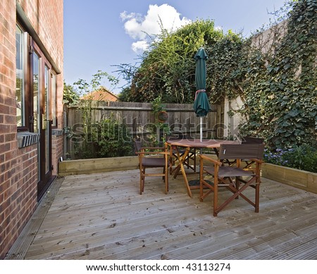 terrace with hard wood deck floor and garden furniture