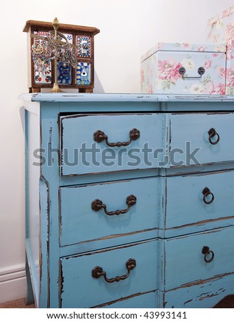 detail of a vintage chest of drawers with jewelery box
