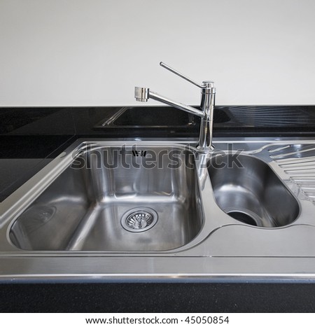 modern stainless steel kitchen sink detail shot