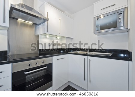 modern white kitchen unit with built-in electric appliances