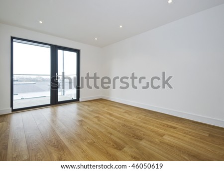 empty room with balcony access and hard wood floor