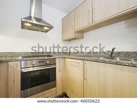 modern kitchen with hard wood finish and granite worktop