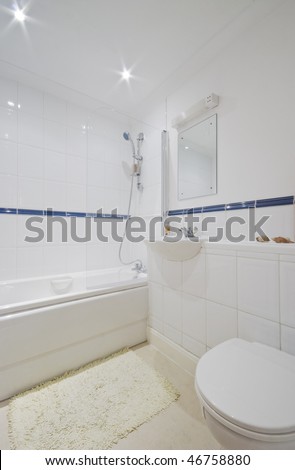classic bathroom with white ceramic floor to ceiling tiles