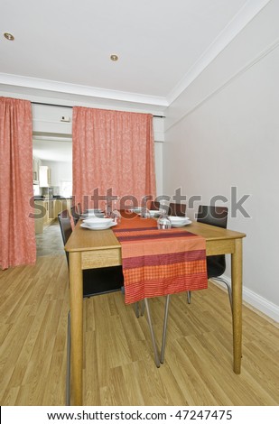 large dining table with red table cloth and setup
