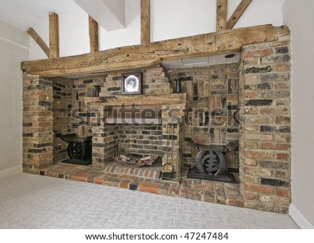 large fireplace with exposed brick and hard wood construction