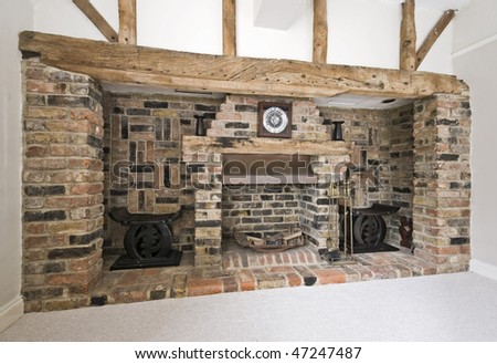 massive fireplace with exposed brick works and hard wood beams