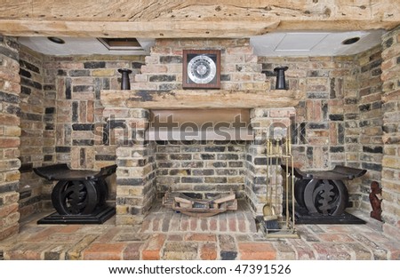 large cottage style fireplace with exposed bricks