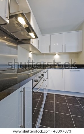 modern white kitchen unit with granite worktop