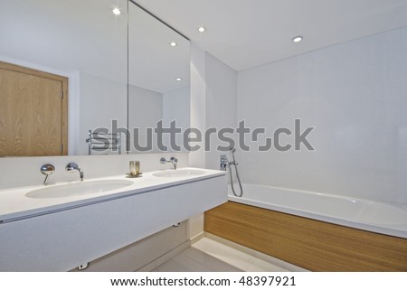 luxury family bathroom with double hand wash basin and floor to ceiling stone tiles