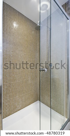 modern luxury shower corner with glass slide door and mosaic tiles