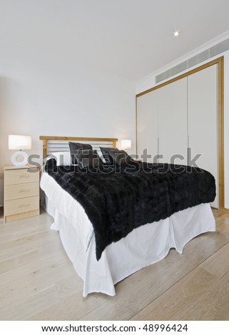 modern bedroom with hard wood floor and built-in wardrobe