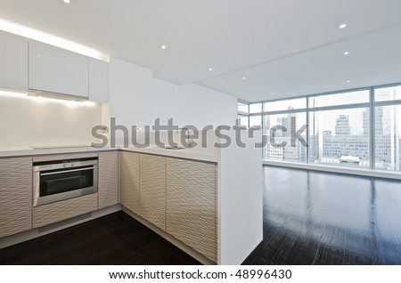modern open plan kitchen with wooden floor throughout and floor to ceiling windows