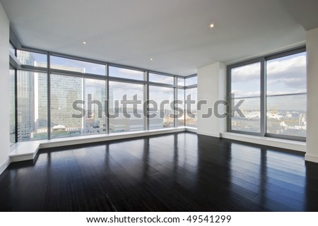 empty apartment with hard wood floor an floor to ceiling windows