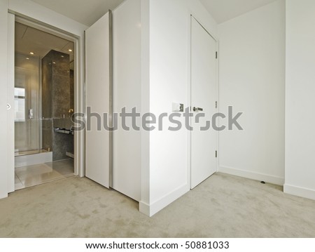 modern bedroom with walk-in wardrobe and en-suite bathroom