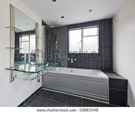 stunning bathroom with modern designer fittings and stone tiles