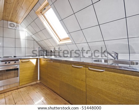 modern kitchen in a loft room with roof window