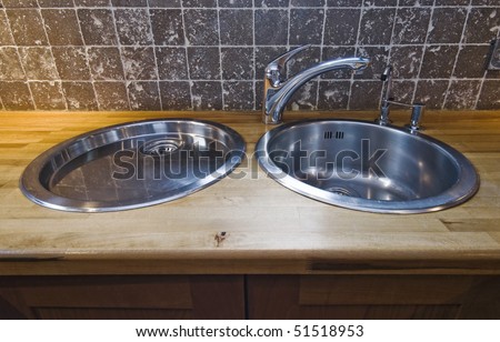 double stainless steel kitchen sink on hard wood worktop
