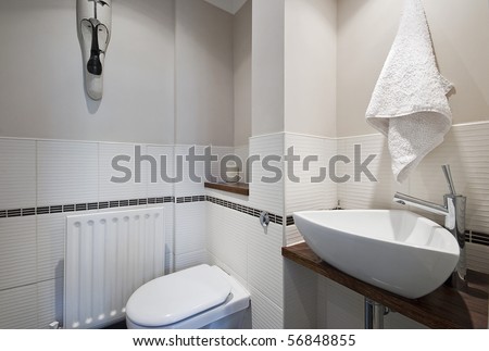 contemporary, designer bathroom with triangle shape hand wash basin