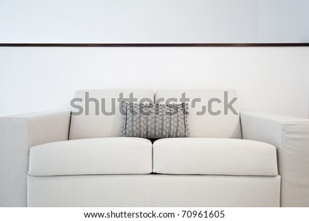 detail of a double seat sofa with cushions