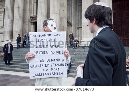 LONDON, UK -OCTOBER 31: A Jewish school boy listening to one of the protesters with banner outside St. Paul\'s Cathedral on 31, 2011 in London.