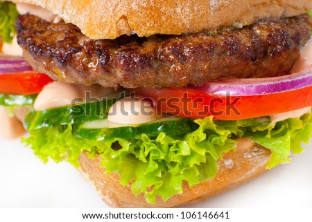 Sanwich with hamburger and vegetables macro shot