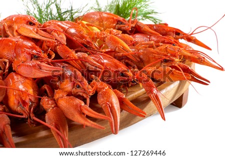 boiled crawfish on the wooden plate on white background