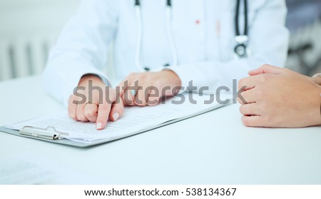 Doctor talking to her female patient at office. Health care and medical concept.