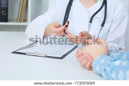 Doctor and patient are discussing something, just hands at the table.