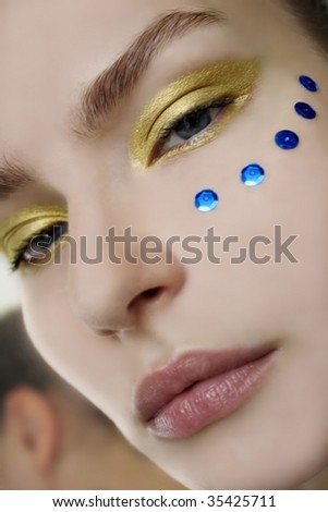 Closeup beauty portrait of a pretty woman with artistic makeup.