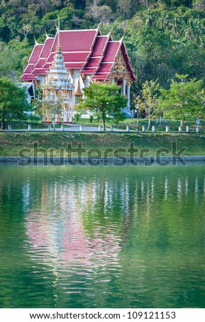 Fairy-tale buddhist temple with reflection in a lake