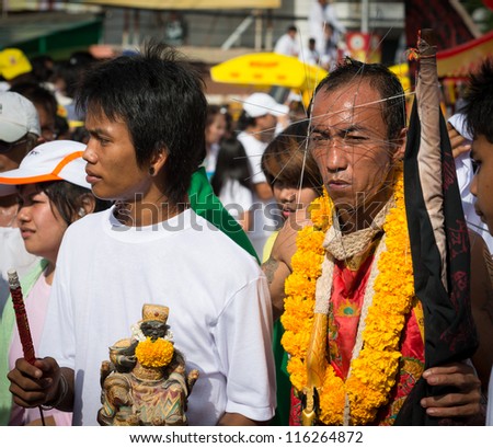 PHUKET, THAILAND - OCTOBER 21: An unidentified devotee of Vegetarian Festival is Mah song, person who invites the spirits of gods to possess their bodies on October 21, 2011 in Phuket, Thailand