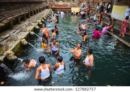 TIRTA EMPUL, INDONESIA - SEP 21: Unidentified people take a bath  in the sacred holy spring water on Sep 21, 2012 in Tirta Empul, Bali, Indonesia. It is famous place for purification from sin.