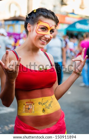 KIEV, UKRAINE - JUL 1: Unidentified Spanish football fan woman goes to EURO 2012 final match Spain vs. Italy on July 1, 2012 in Kiev, Ukraine