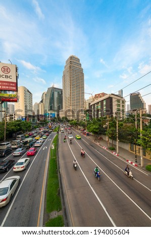 BANGKOK, THAILAND - 21 NOV 2013: Traffic jam on the city streets with billboards, modern buildings in rush hour and skyscrapers on background