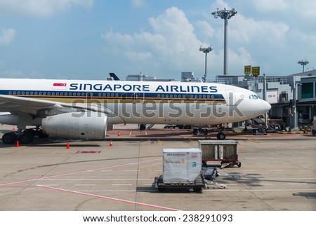 SINGAPORE - 02 JAN 2014: Singapore Airlines Airbus A330-300 airplane stand on parking near passenger gate for boarding in Changi airport.