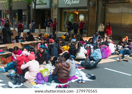 HONG KONG, CHINA - 18 JAN 2015: Meeting of mostly female, Filipino workers on a street in downtown Hong Kong, China.